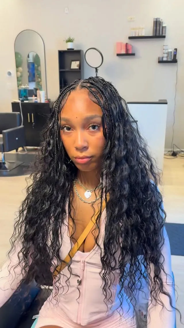 Long black boho braids with loose wavy curls and front braid detail, hairstylist in Houston, TX