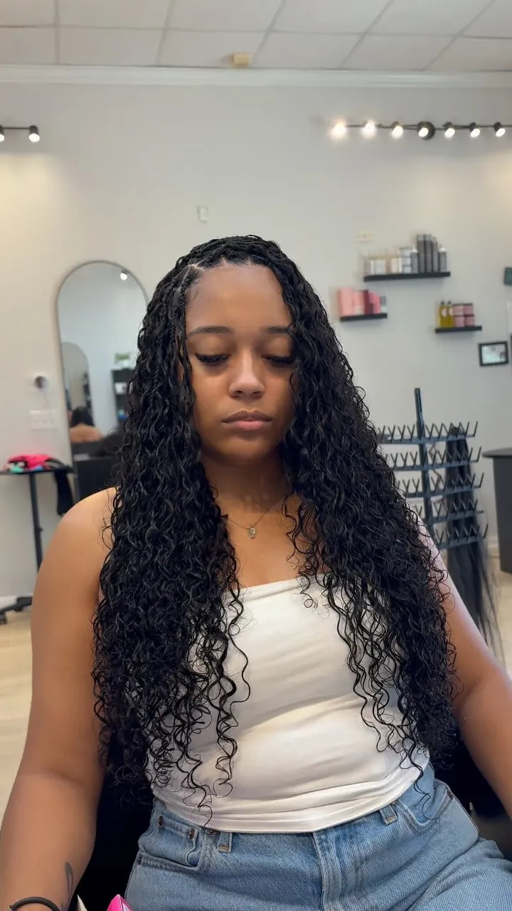 Long black curly boho braids with middle part, hairstylist in Houston, TX