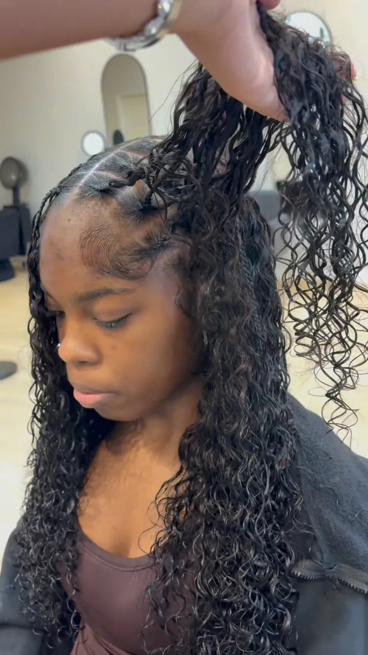 Curly boho braid style with lifted section showing scalp parting, hairstylist in Houston, TX