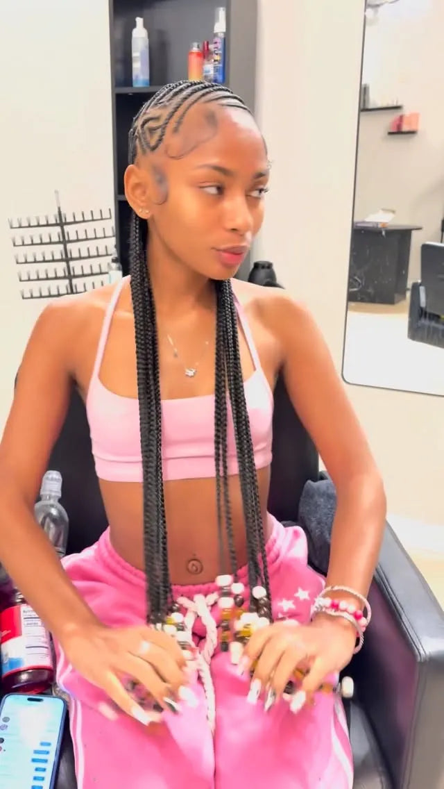 Long stitch braids with creative side part design and sleek edges, hairstylist in Houston, TX