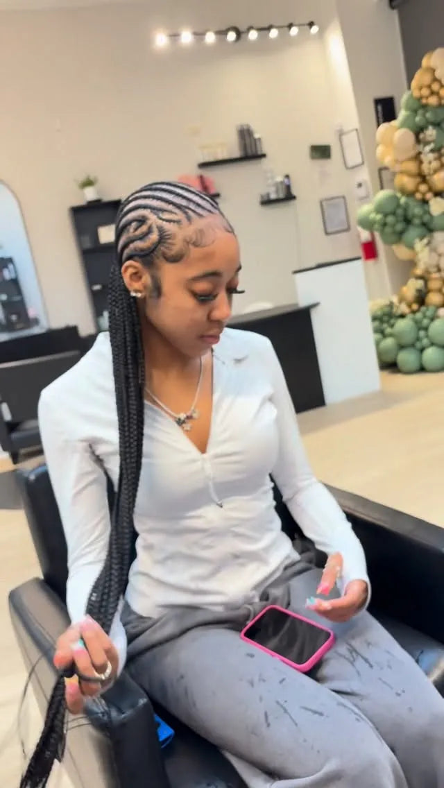 Long feed-in stitch braids with curved scalp design and sleek edges, hairstylist in Houston, TX