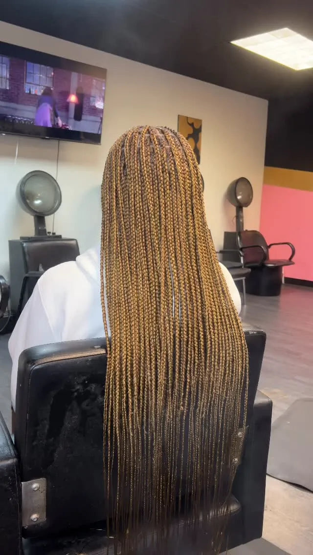 Long small knotless box braids in honey blonde and brown tones, Stylist located in Homestead, FL