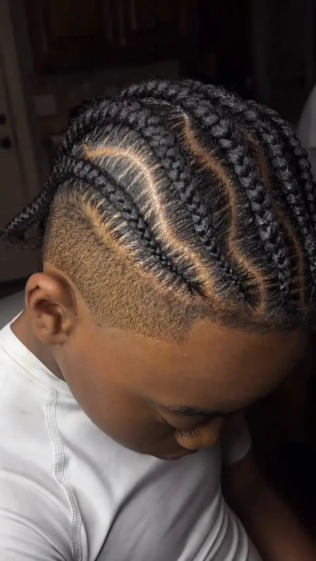 Kids curved cornrow braids with low braided bun, Stylist located in Smyrna, GA