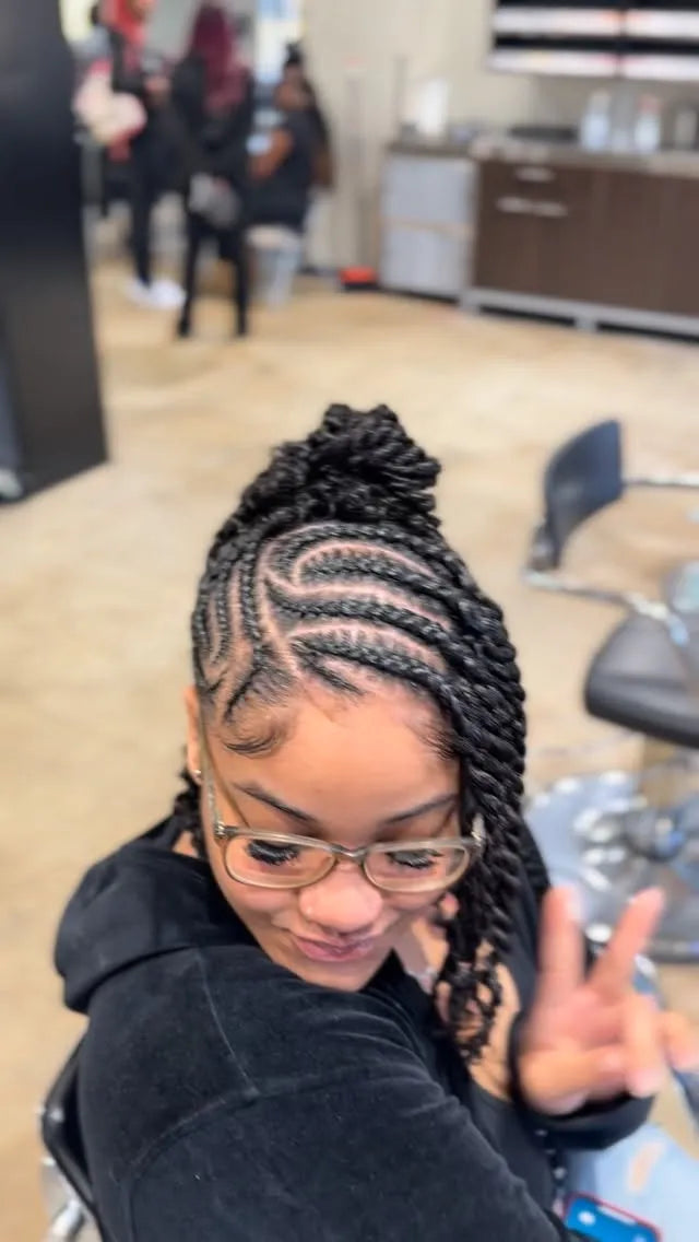 Person with braided hair in a salon setting