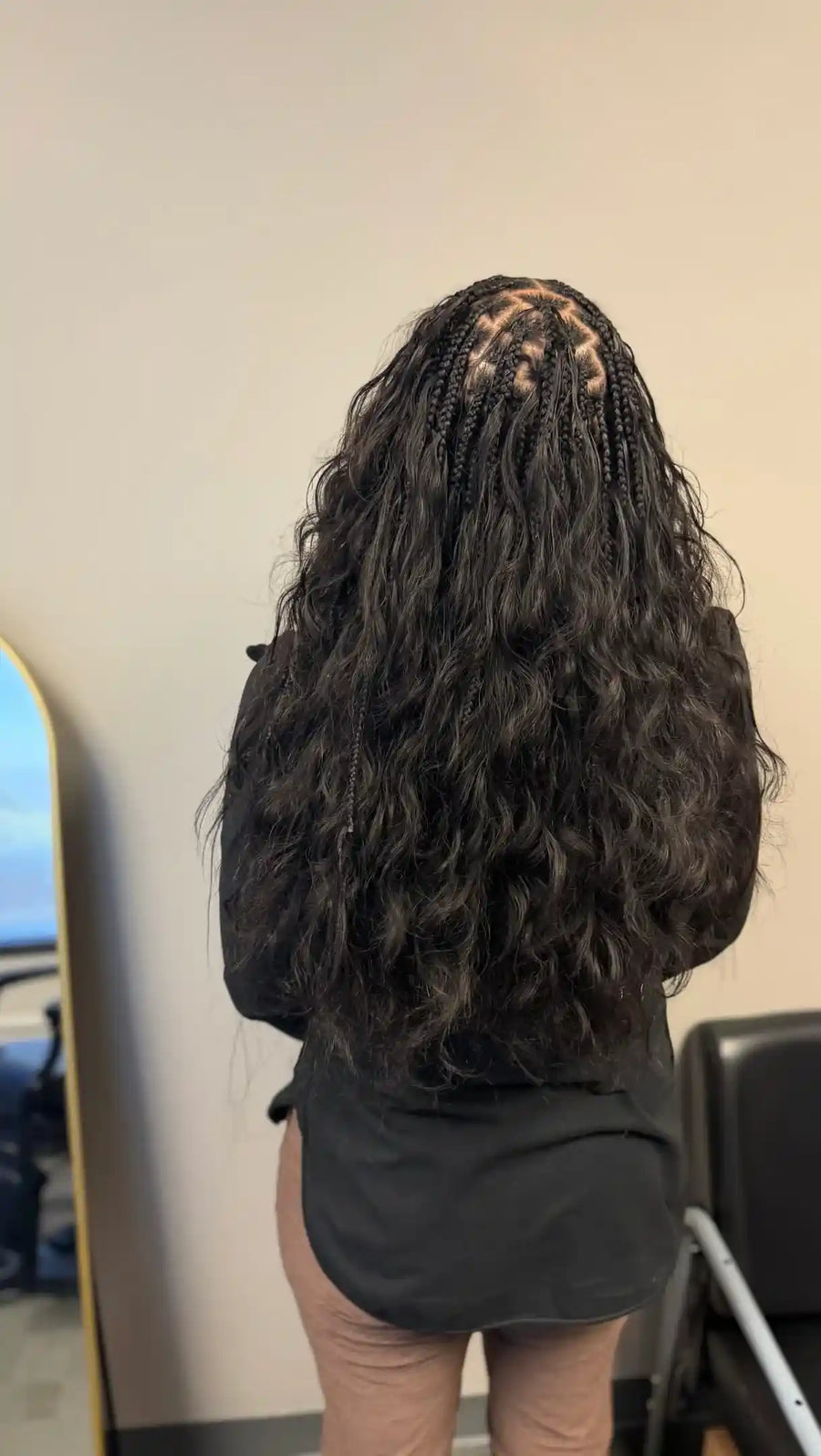 Person with braided hair in a salon setting
