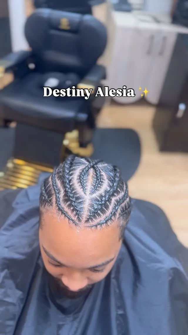 Person with braided hair in a salon setting