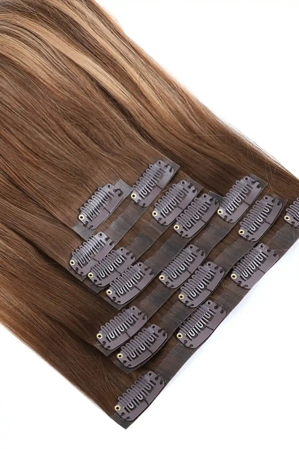 Detail of double drawn seamless clip in hair extensions brown with blonde highlights