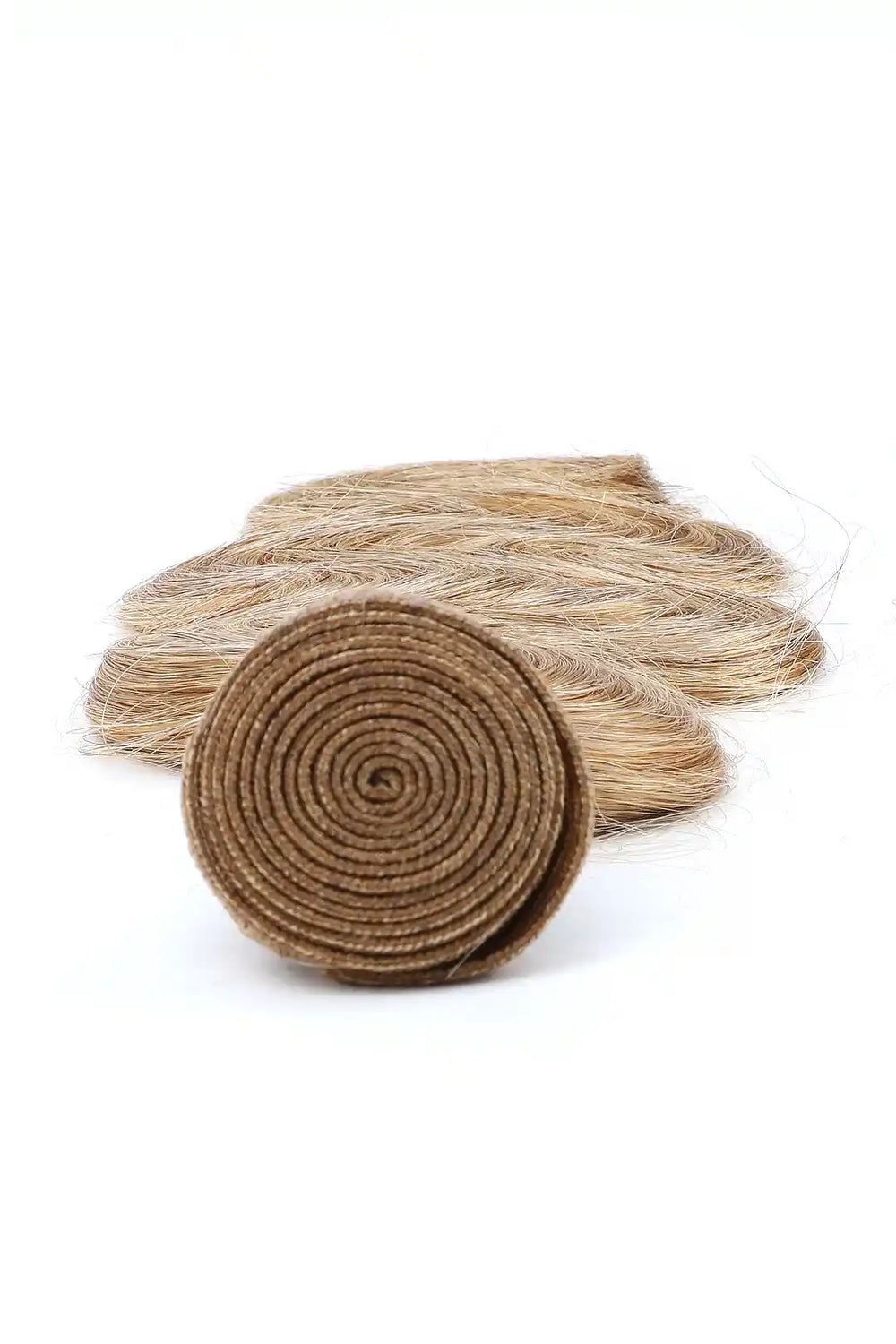 Detail of the ends of 27 honey blonde body wave hair bundles sew in extensions