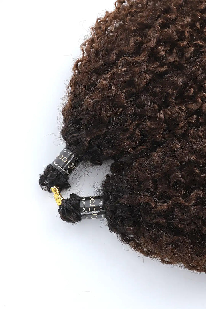 Detail of the ends of #T1B/4 Ombre color tight curly feather crochet human hair