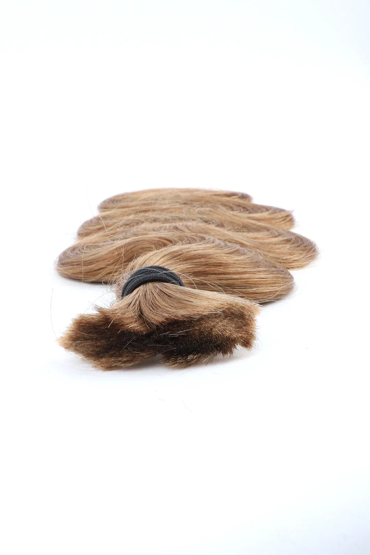 Detail of the ends of light blonde body wave bulk human hair