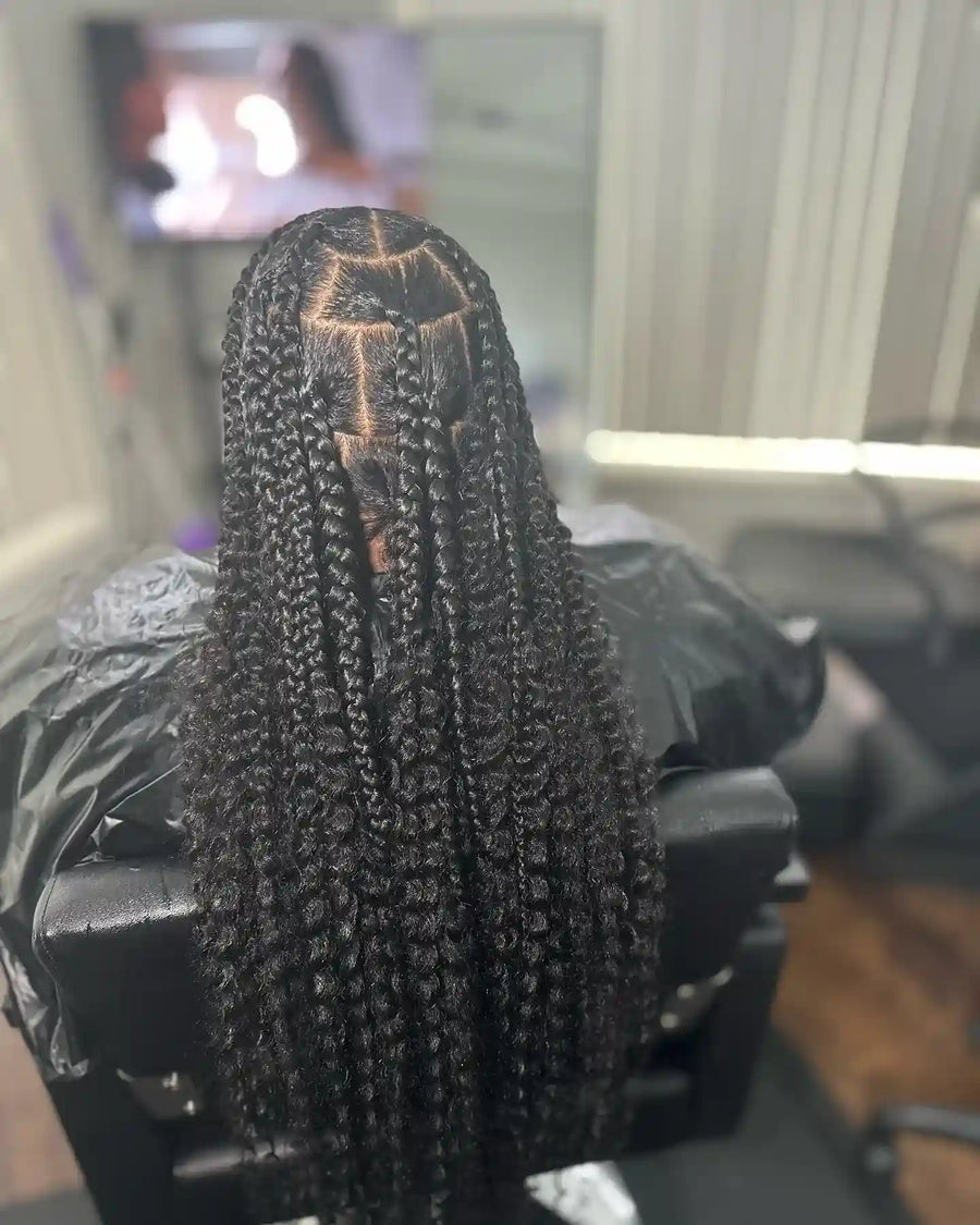 Long knotless box braids with loose curls and a full bohemian finish, hairstylist located in Fairview Heights, IL