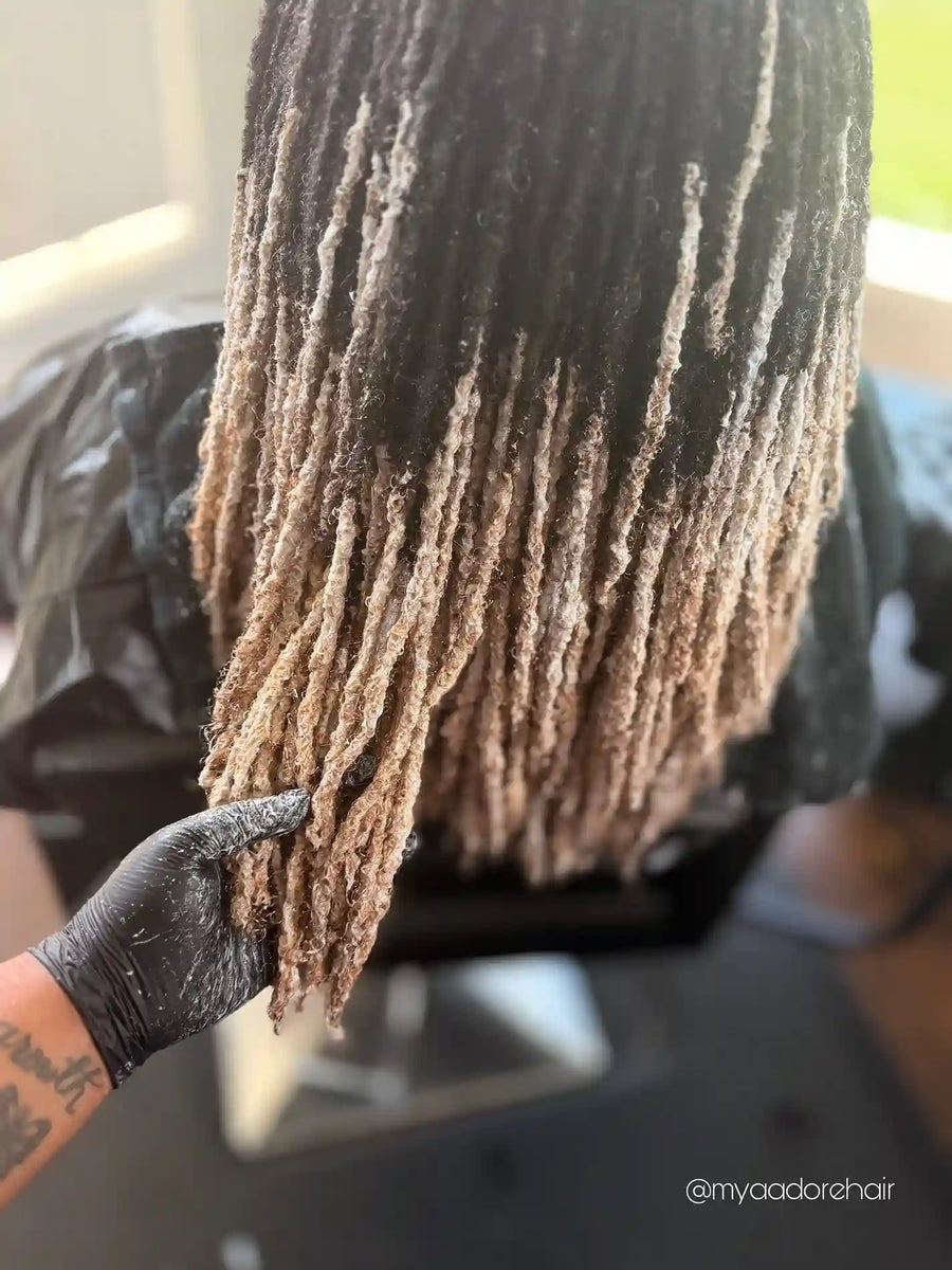 Shoulder-length ombre locs fading from natural black to light blonde, hairstylist located in Fairview Heights, IL