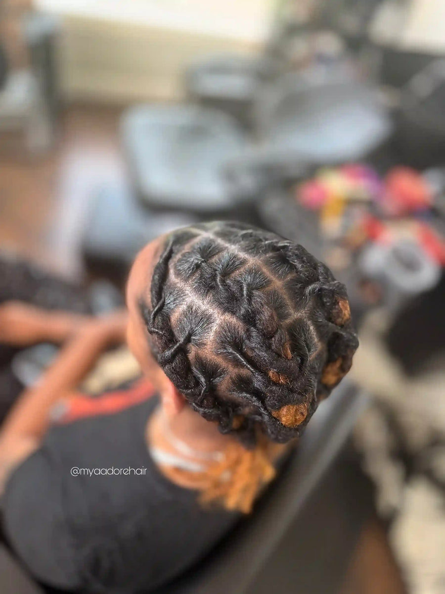 Short two-strand twists pinned into a textured updo with copper highlights, hairstylist located in Fairview Heights, IL