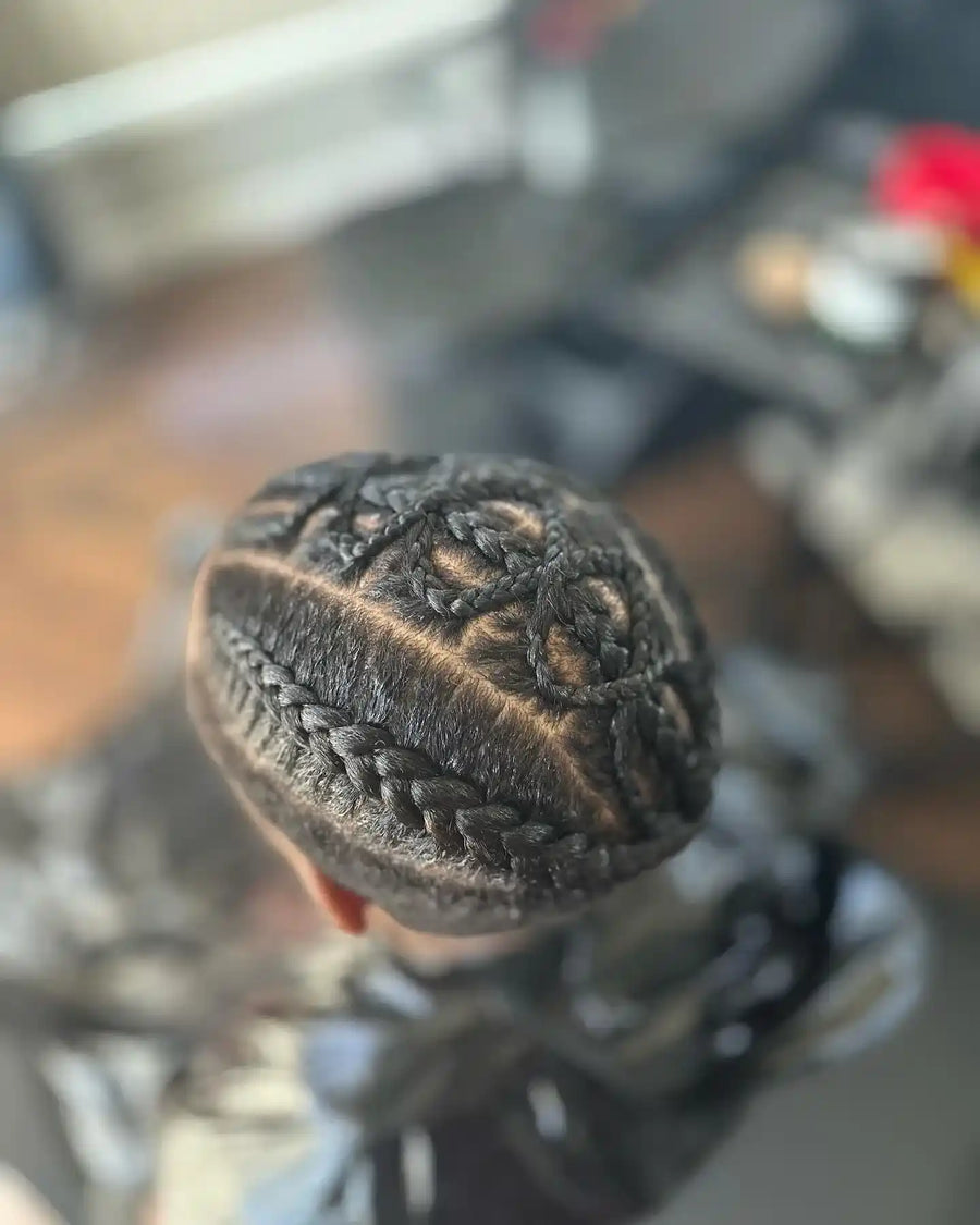 Braided updo with curved feed-in cornrows and an intricate crown pattern, hairstylist located in Fairview Heights, IL