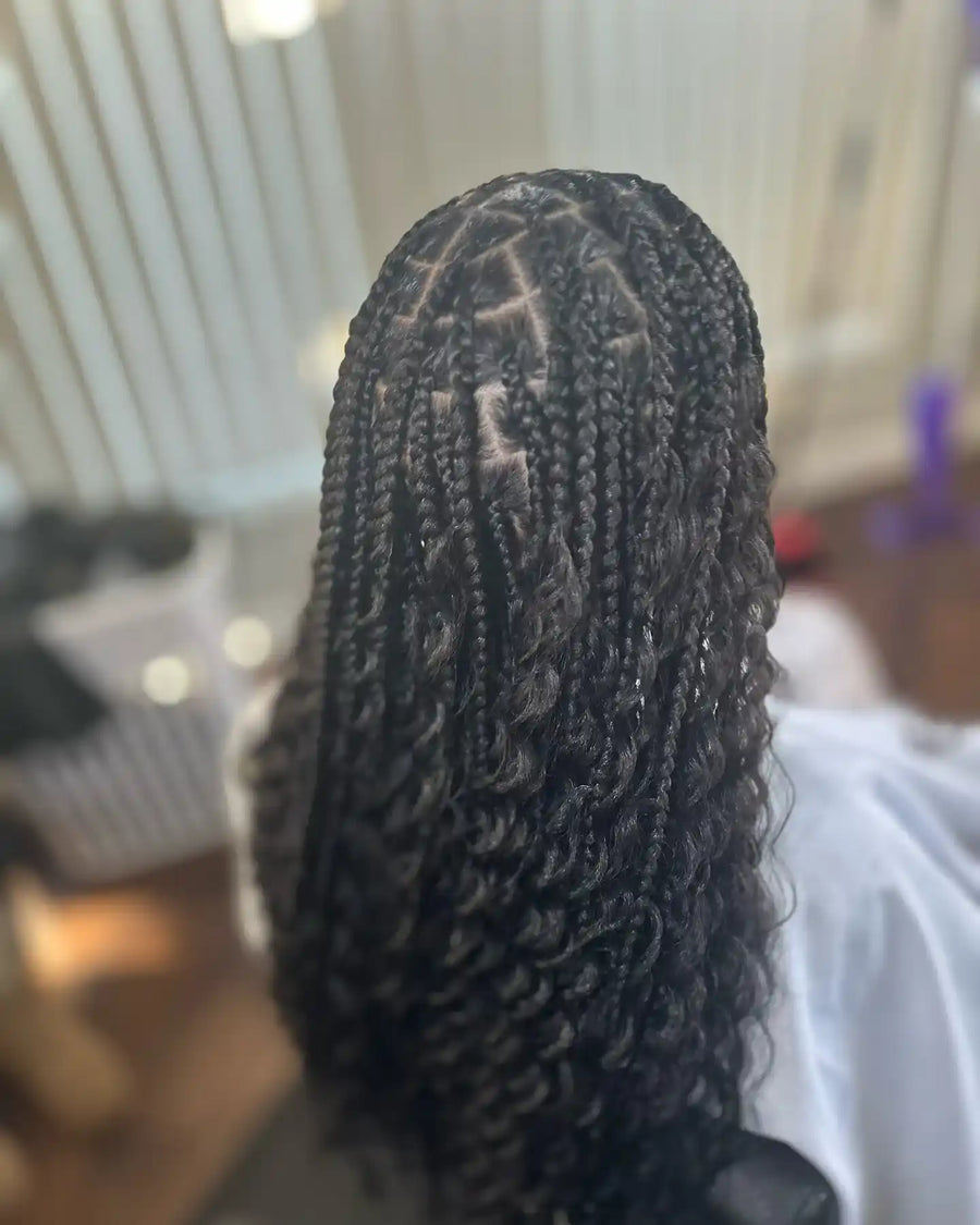 Long black boho knotless braids with loose curly strands and defined ends, hairstylist located in Fairview Heights, IL