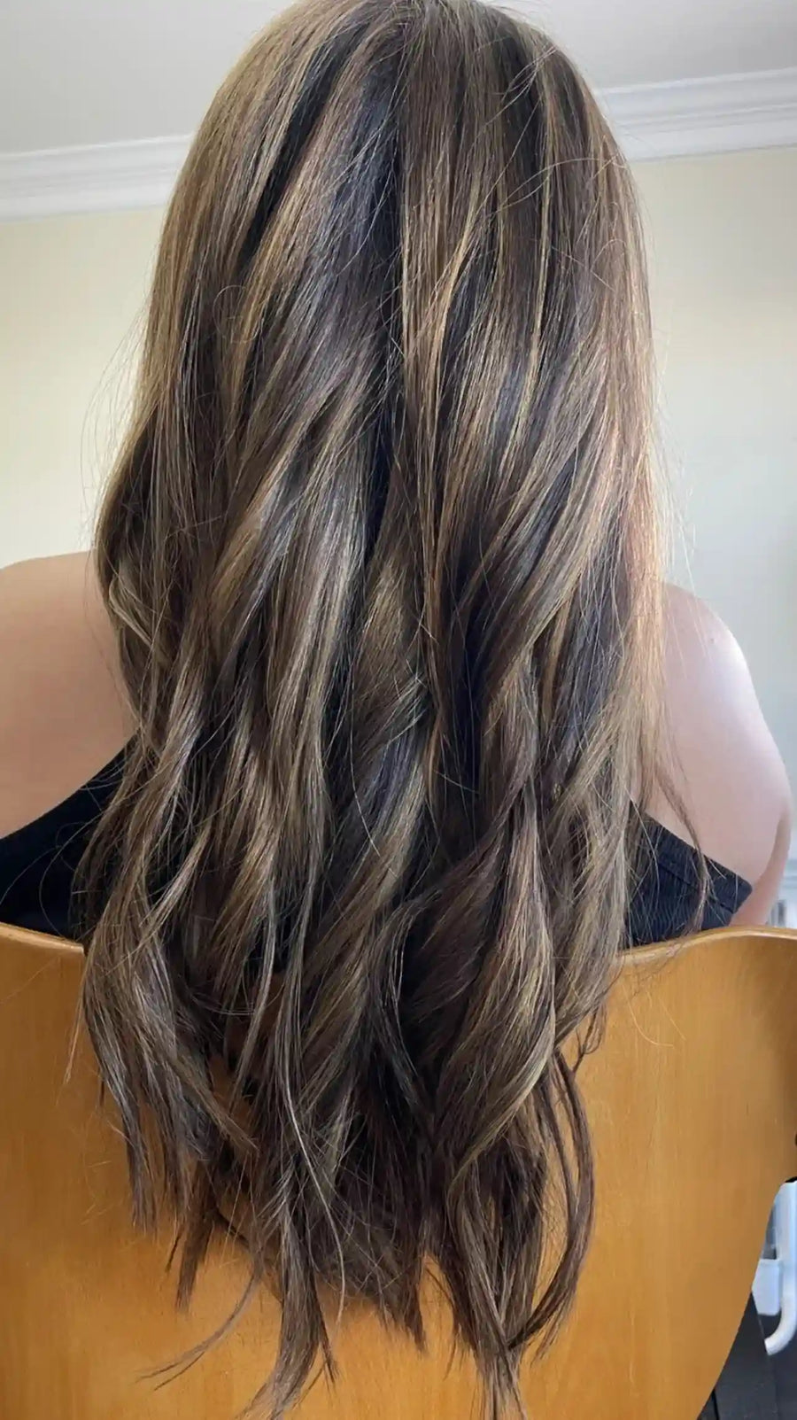 Long brunette balayage hairstyle with ash blonde highlights and soft waves, hairstylist located in Rockwall, TX
