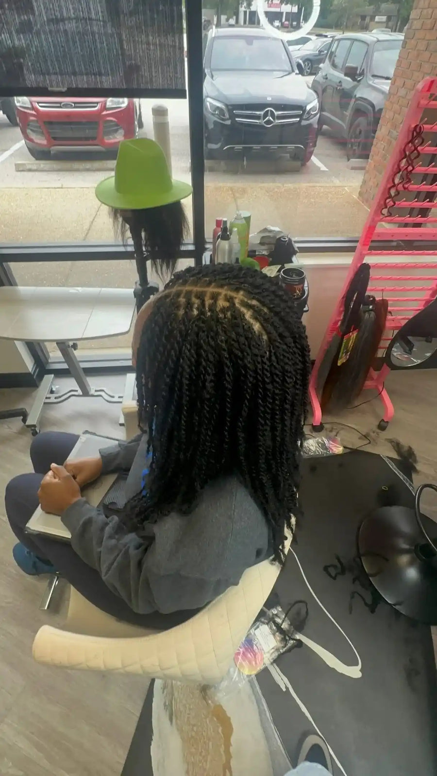 Shoulder-length natural black two-strand twists with neatly sectioned roots and a textured finish, Stylist located in Bartlett, TN