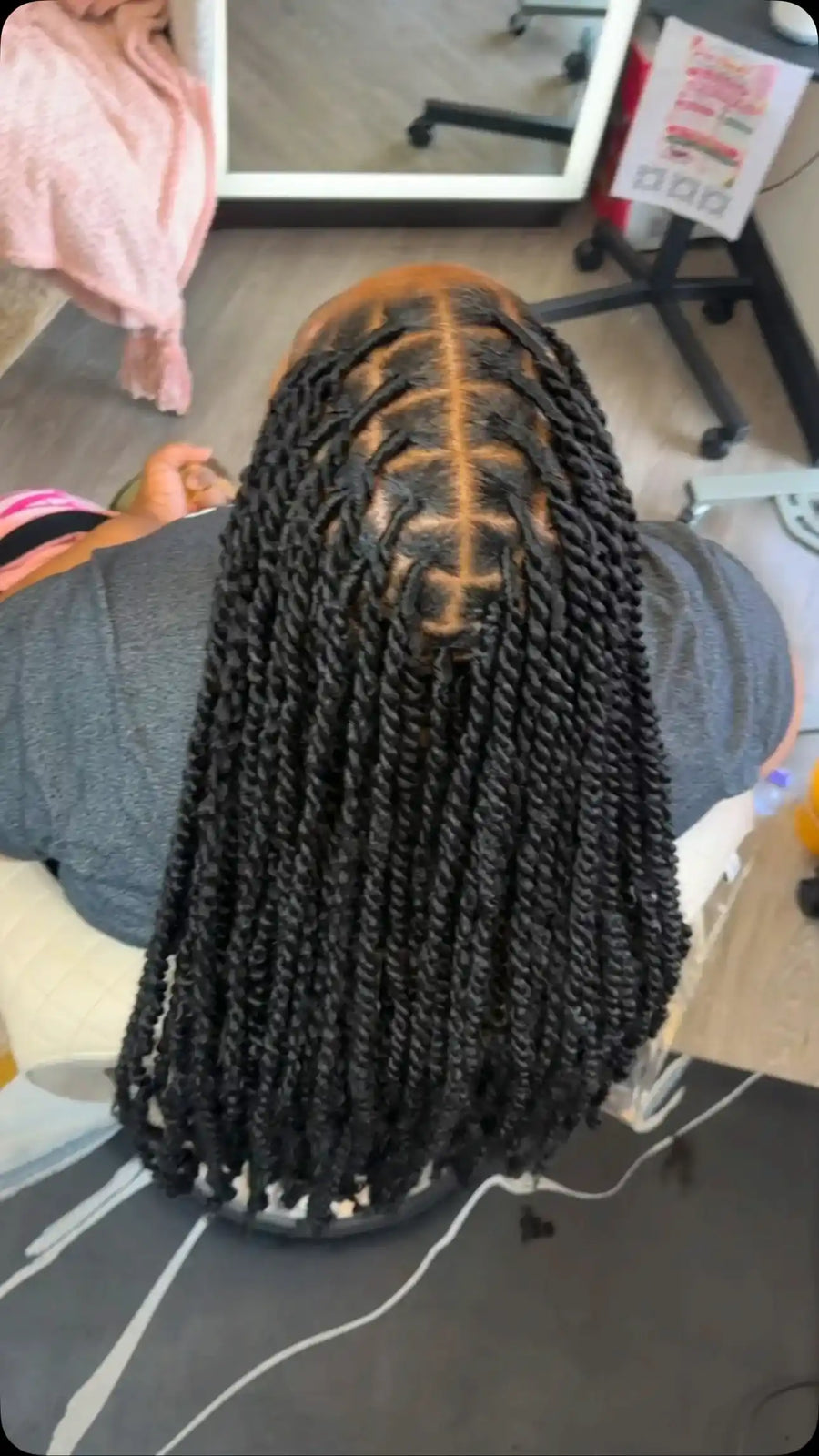 Medium-length black two-strand twists with clean geometric parting and a center-parted hairstyle, Stylist located in Bartlett, TN