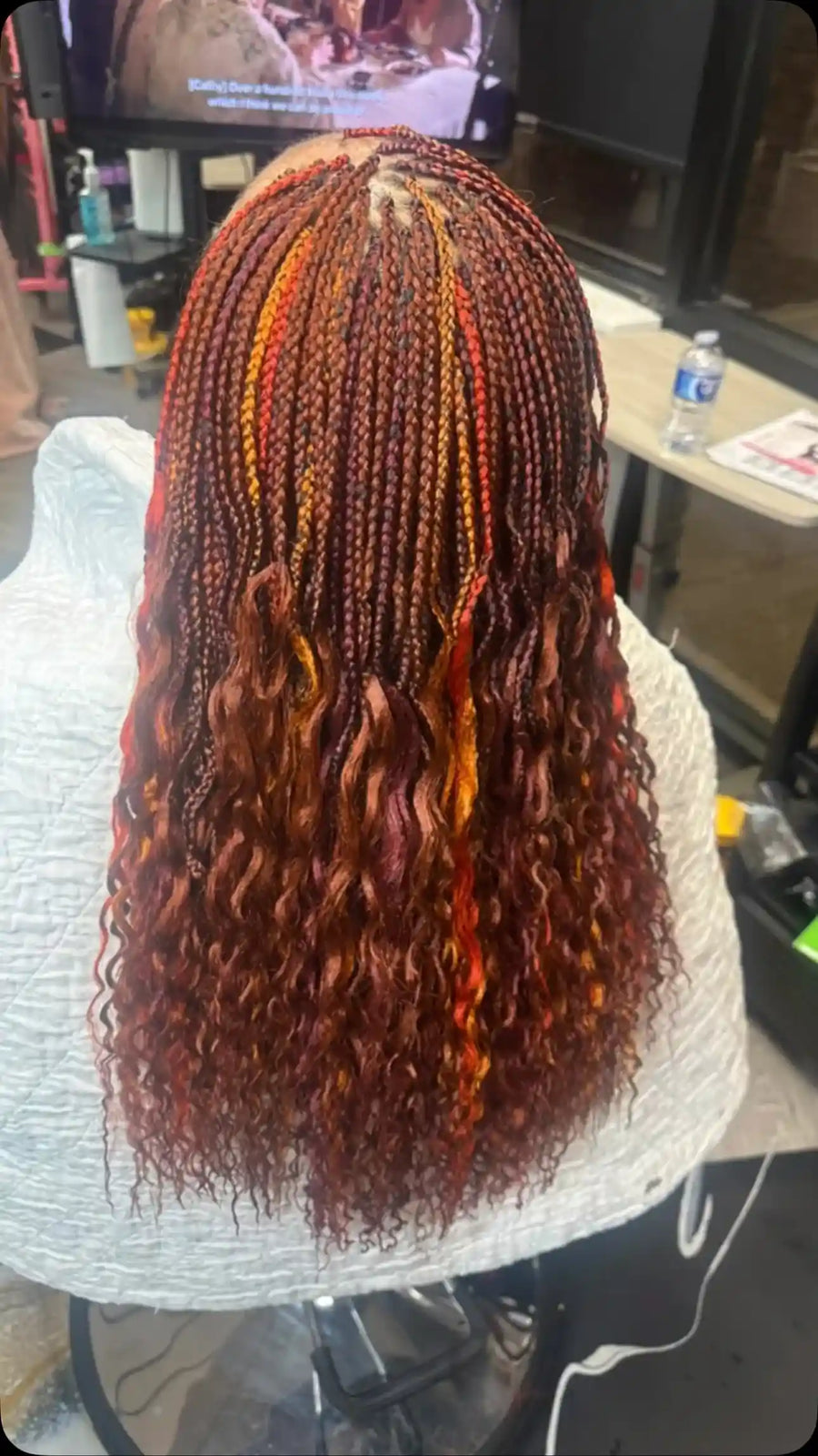 Long burgundy and copper boho braids with red and orange highlights and loose curly ends, Stylist located in Bartlett, TN