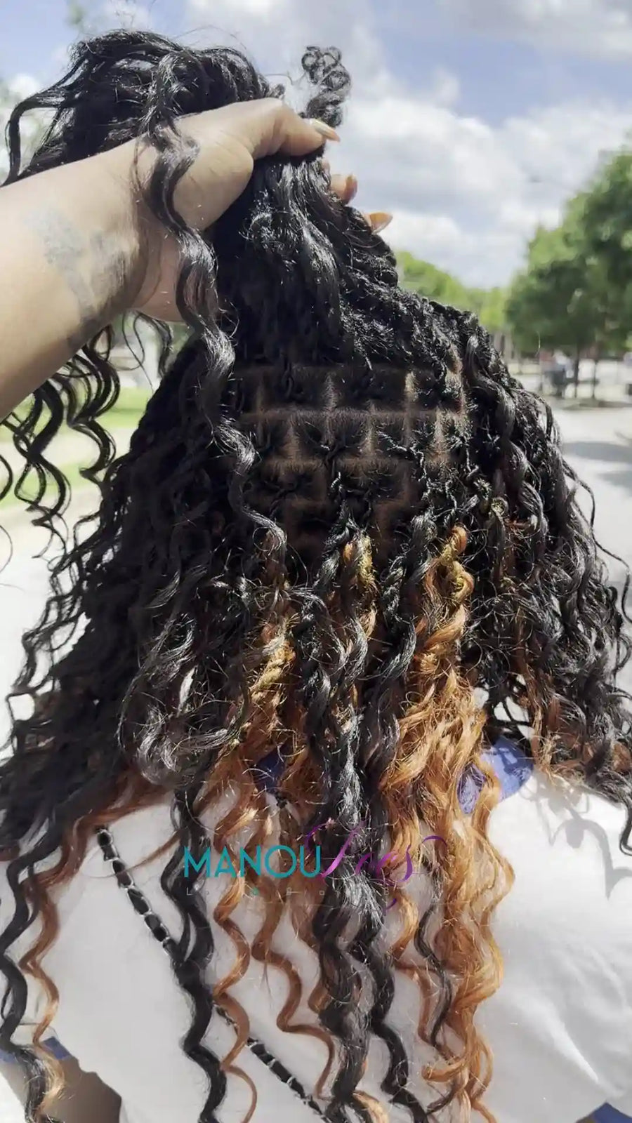 Loc retwist with curly ends and blonde highlights, hairstylist in Atlanta, GA