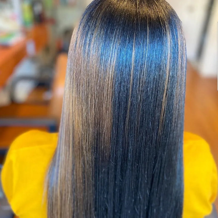 Person with blue and black hair in a salon setting
