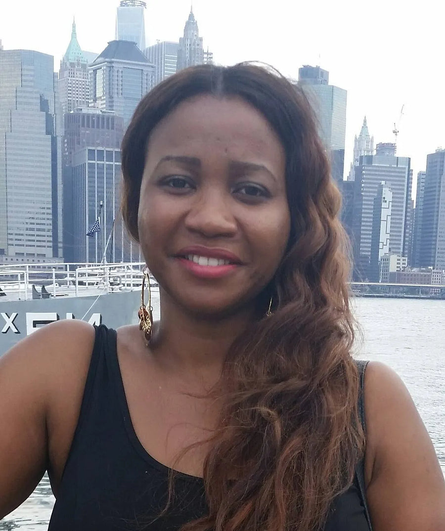 Woman with a city skyline and water in the background