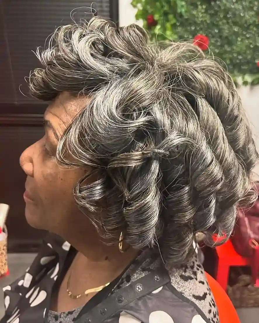 Short silver and black pixie cut styled with large sculpted curls, hairstylist located in Glendale, AZ