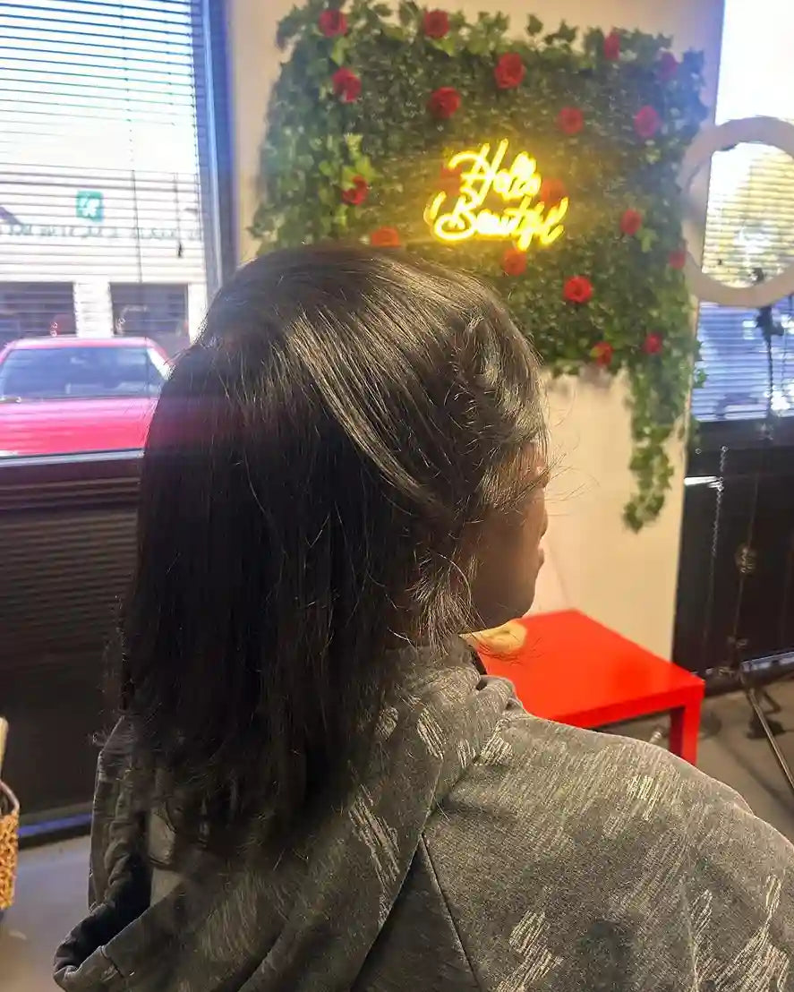 Sleek shoulder-length silk press with a deep side part and softly bumped ends, hairstylist located in Glendale, AZ