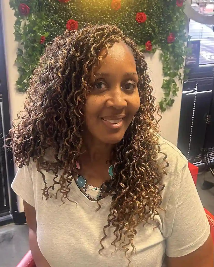 Long side-parted crochet curls with warm brown highlights and defined ringlets, hairstylist located in Glendale, AZ