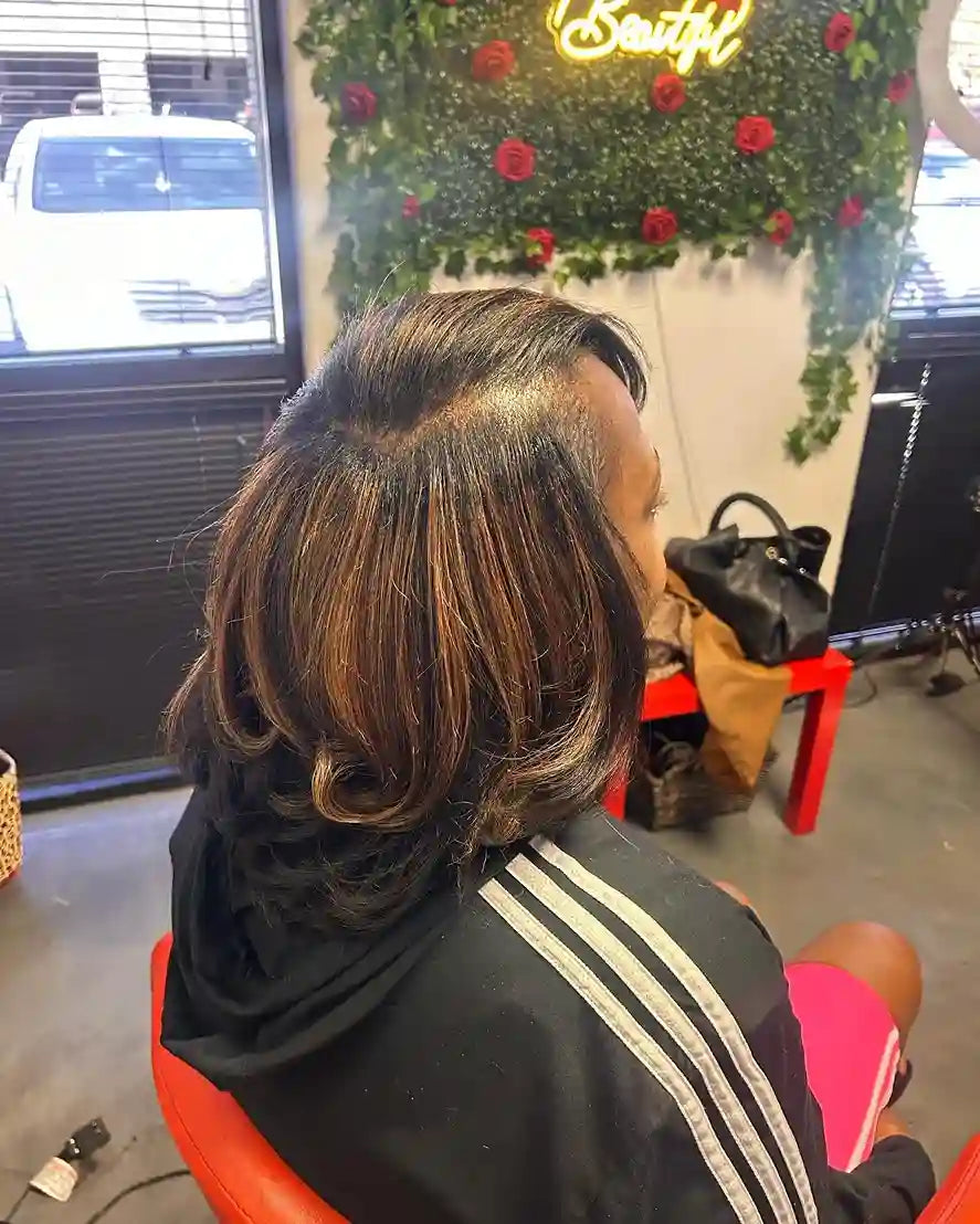 Layered shoulder-length silk press with caramel highlights and curled-under ends, hairstylist located in Glendale, AZ