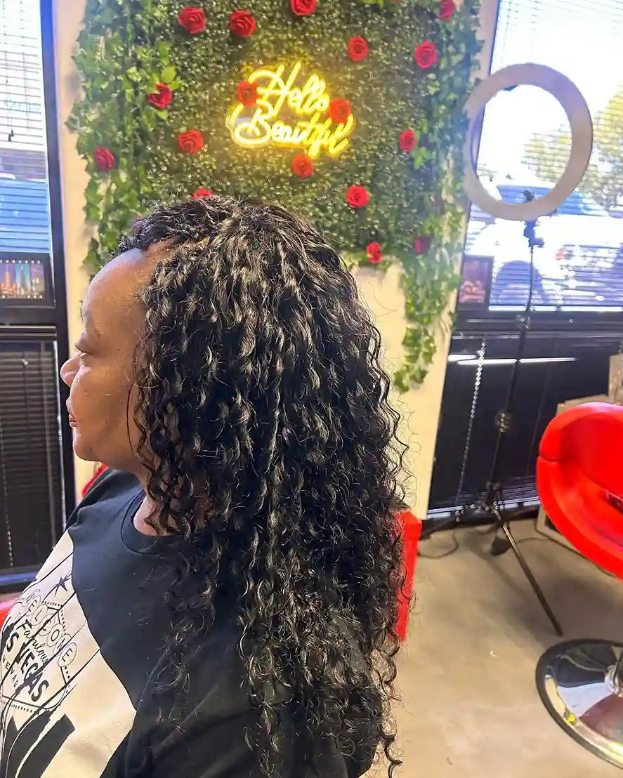 Long black curly crochet hairstyle with loose spiral curls and side-swept volume, hairstylist located in Glendale, AZ