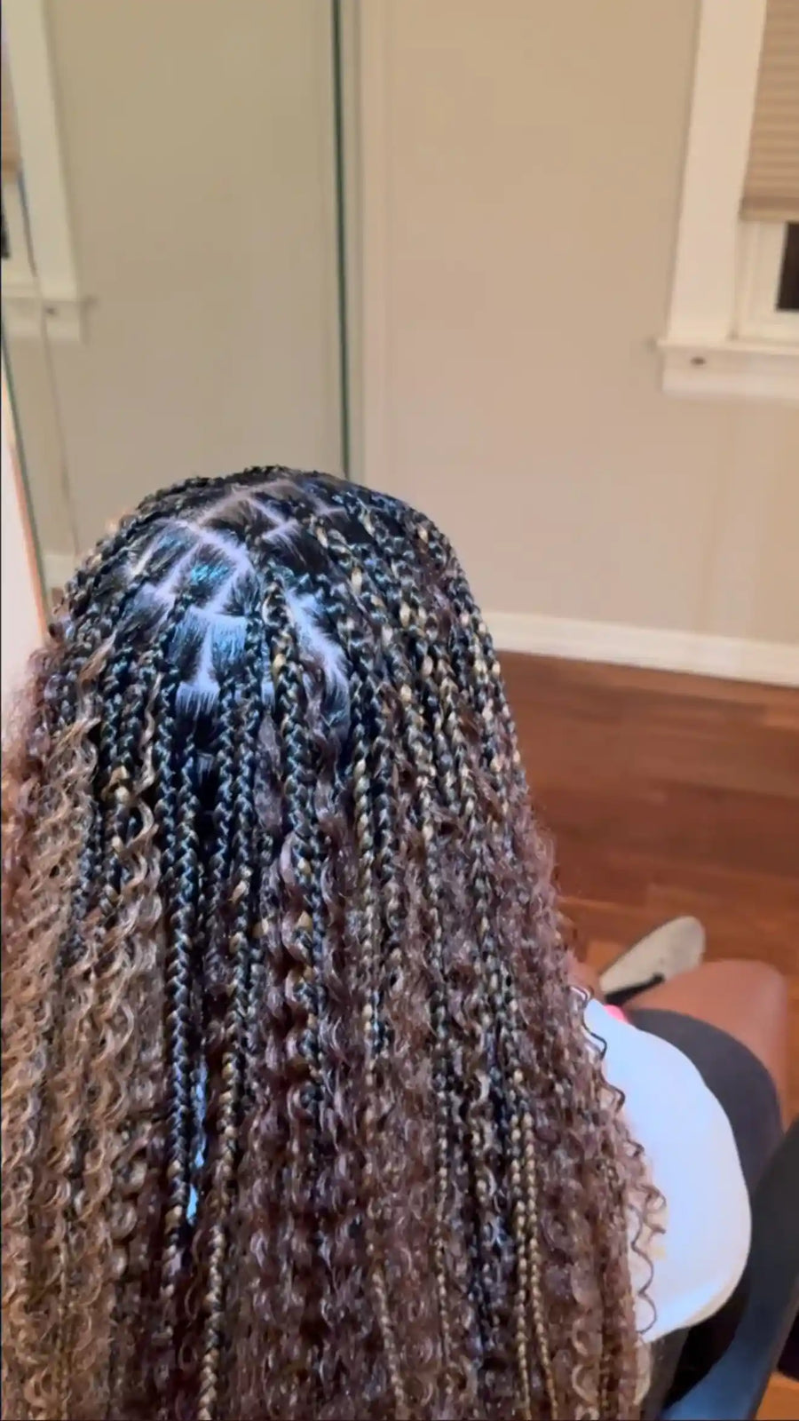 Close-up of braided hair with a neutral background