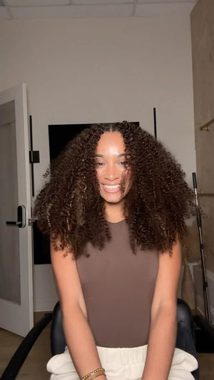 Ins influencer niqslocs showing the braiding process of dark brown 4 burmese curly with spiral curls feather crochet miracle knots hair