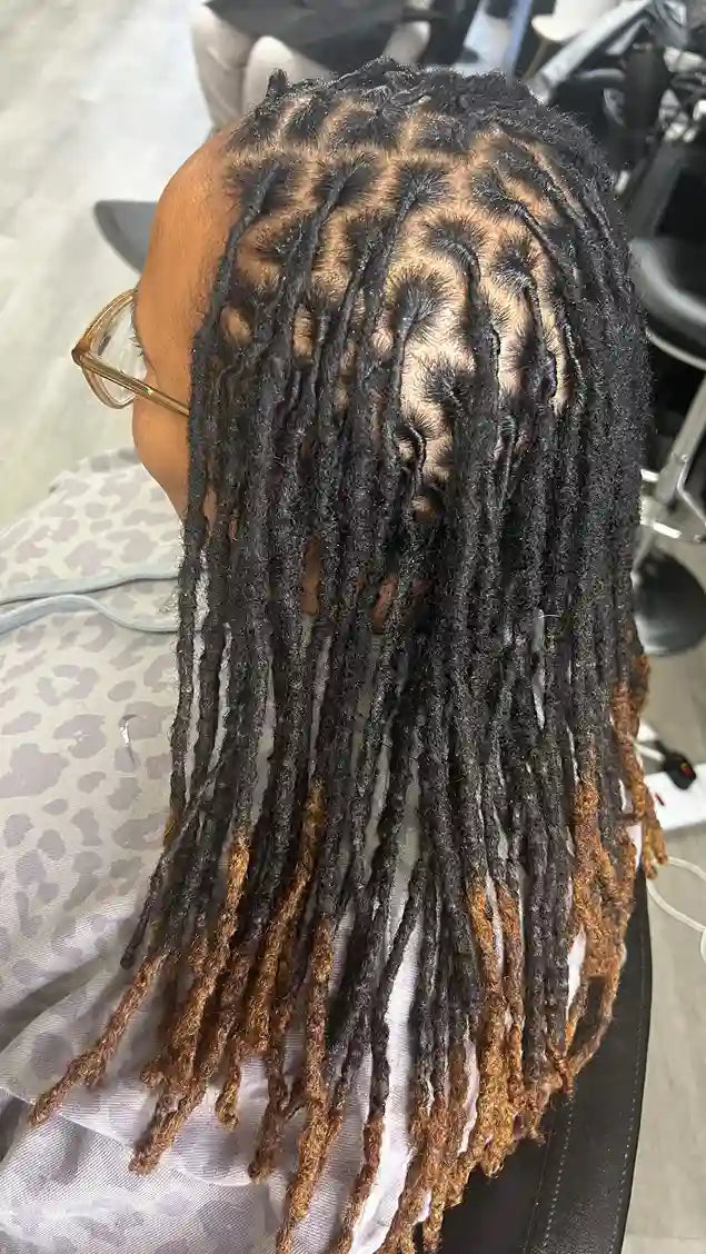 Long loc retwist hairstyle with geometric parting and blonde tips, hairstylist located in Philadelphia, PA