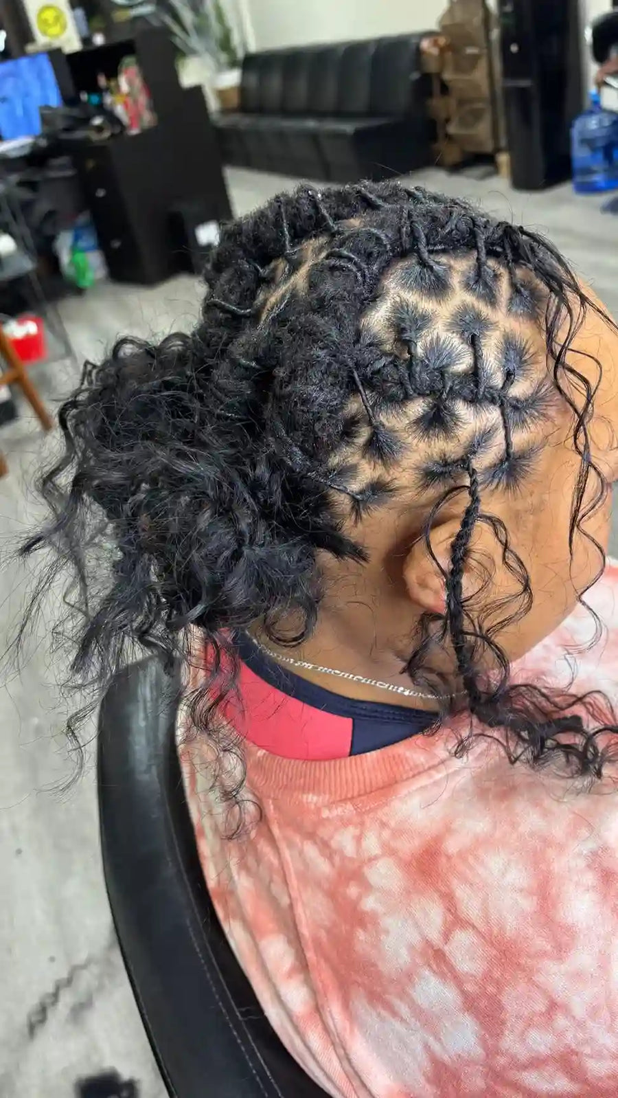 Braided updo with curly tendrils and sectioned parting, hairstylist located in Philadelphia, PA
