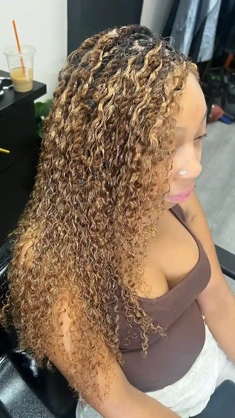 Highlighted curly loc hairstyle with loose spiral texture, hairstylist located in Philadelphia, PA