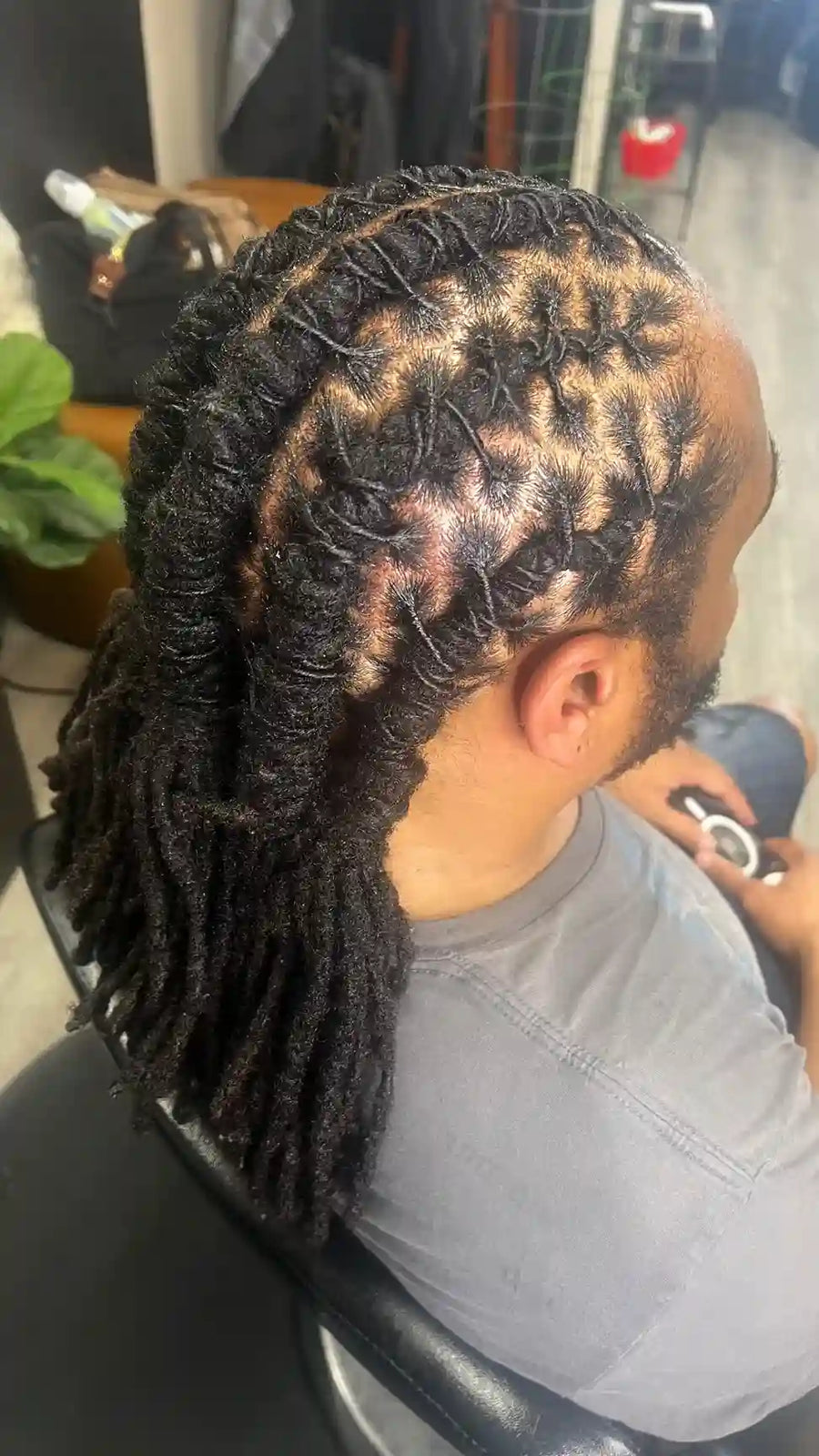 Men’s loc retwist with geometric parting and tied back dreadlocks, hairstylist located in Philadelphia, PA