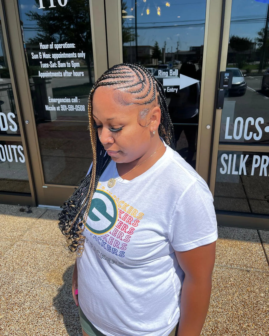 Side-swept stitch braids with blonde accent braids and curled ends, hairstylist in Memphis, TN