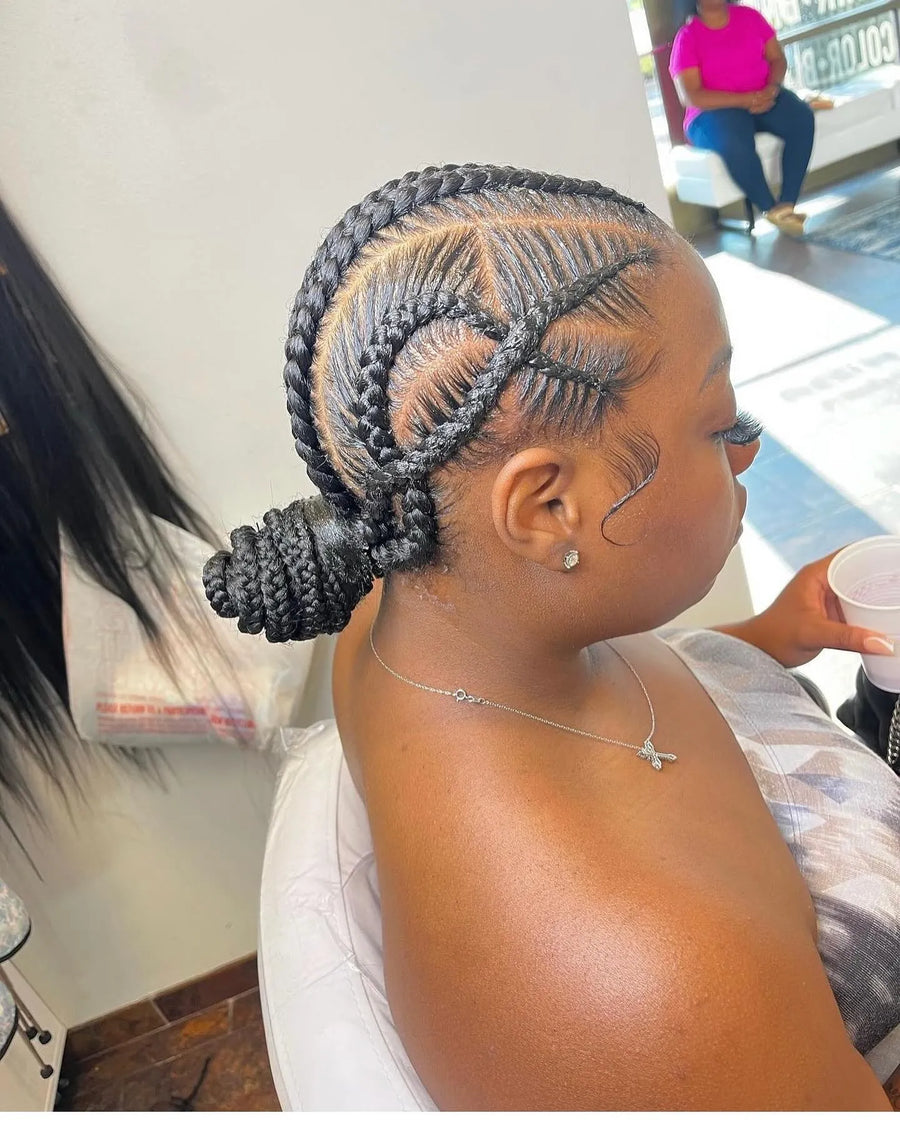 Creative stitch braids with crisscross details and a low braided bun, hairstylist in Memphis, TN
