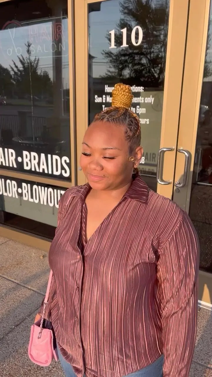 Blonde braided top bun with detailed feed-in cornrows and laid edges, hairstylist in Memphis, TN