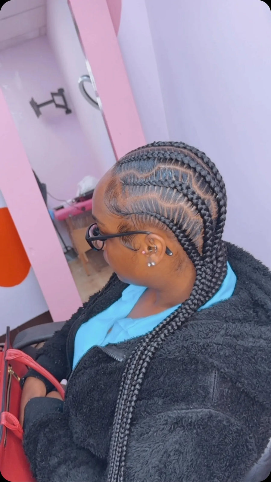 Long curved stitch braids with a side-swept braided ponytail, hairstylist in Memphis, TN