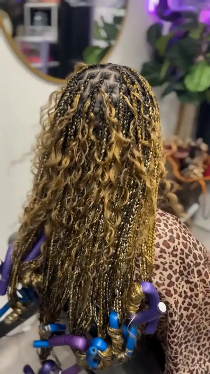 Honey blonde boho knotless braids with loose curly strands and curled roller-set ends, hairstylist located in Franklin Square, NY