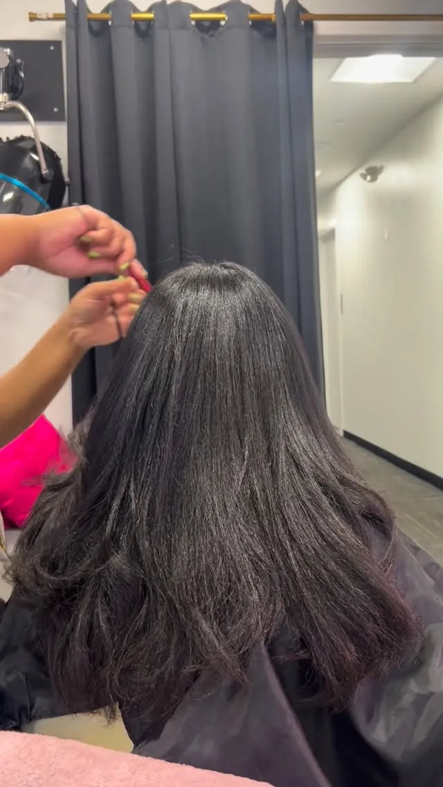 Sleek black silk press with soft layered curls and smooth natural shine, hairstylist located in Franklin Square, NY