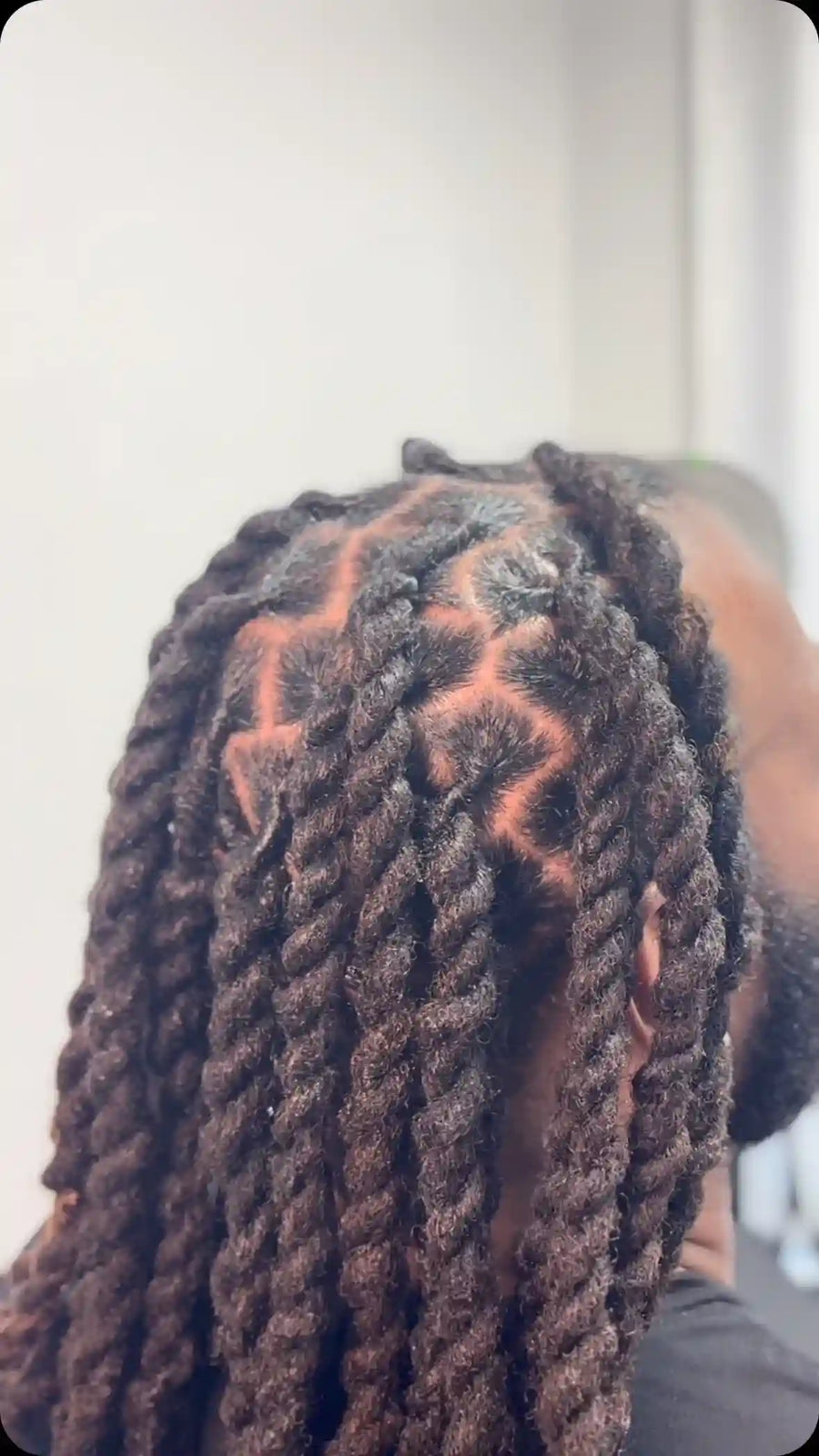 Long chunky two-strand twists with clean geometric parts and a natural textured finish, hairstylist located in Chesterfield, VA