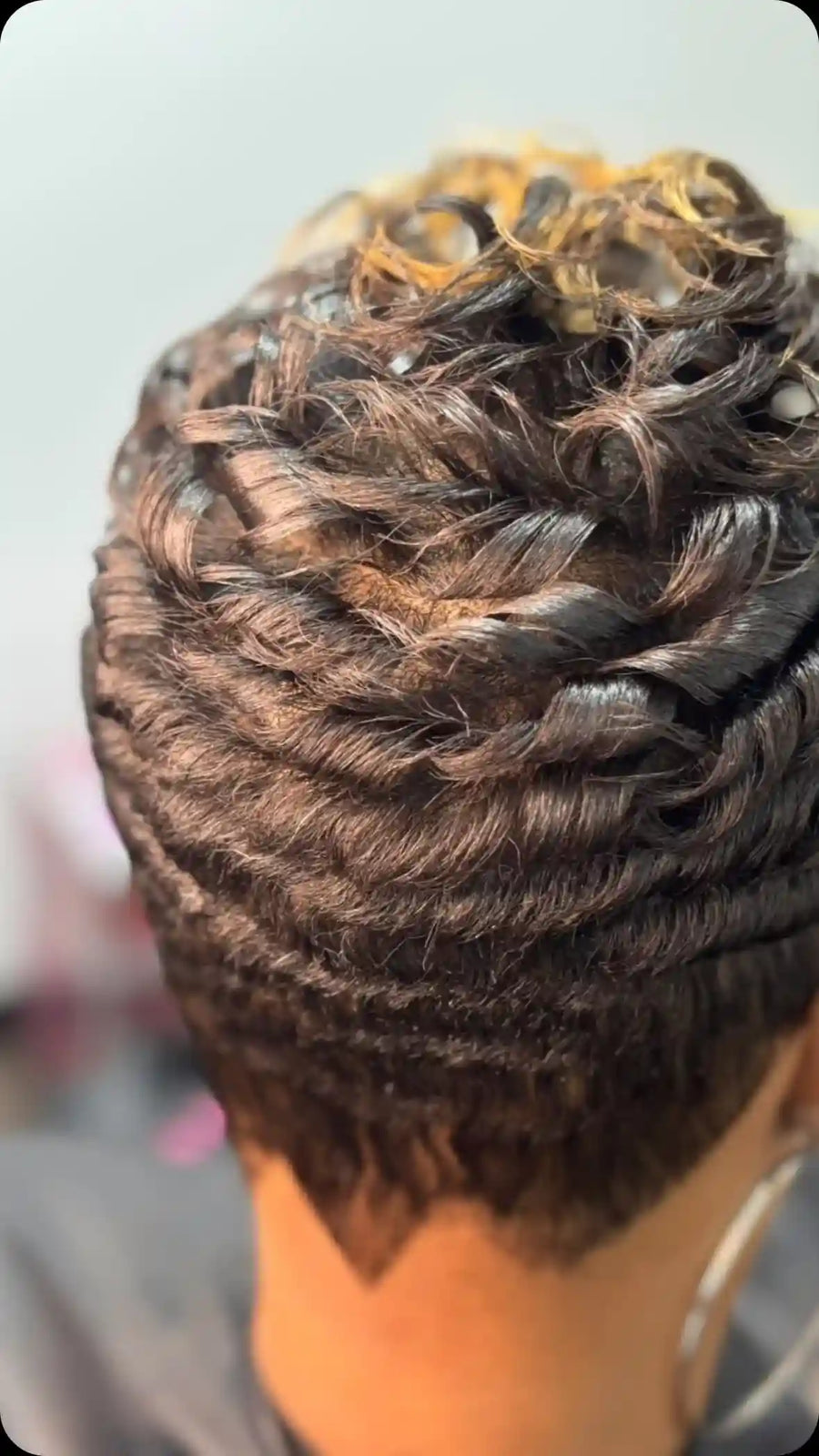 Short brown braided updo with basket-weave braiding, twisted loops, and pinned curls, hairstylist located in Chesterfield, VA