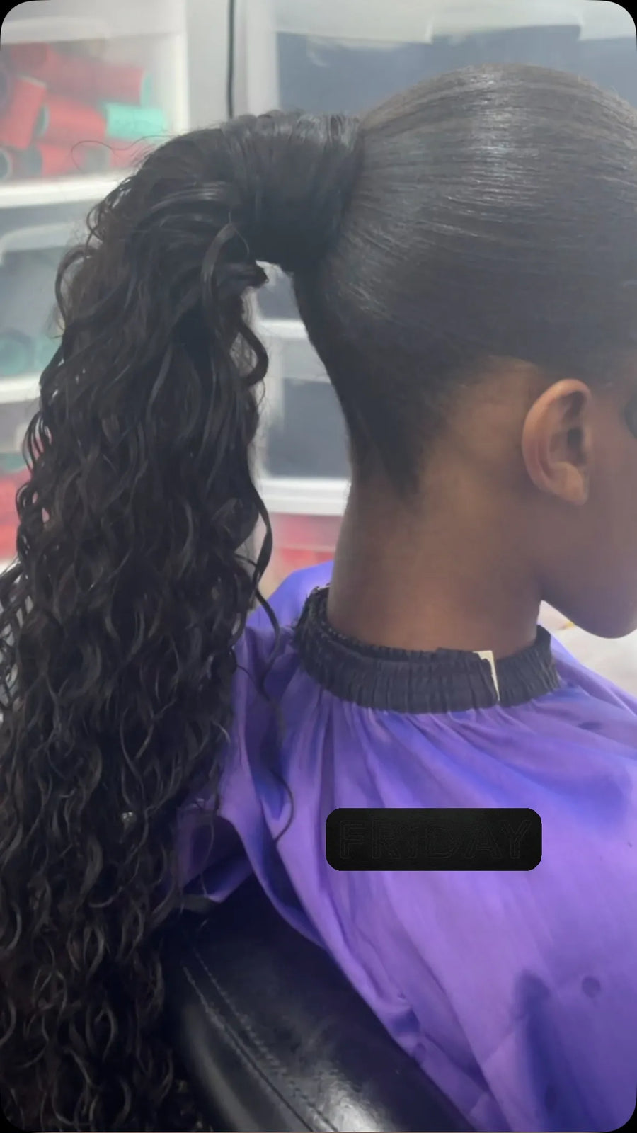 Sleek high ponytail with long black loose-wave curls and a smooth polished base, hairstylist located in Chesterfield, VA