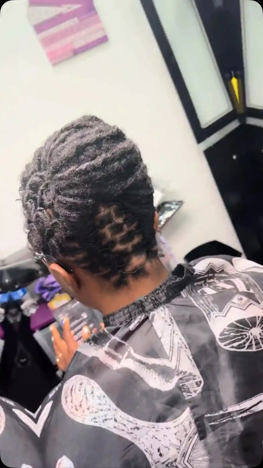 Short natural flat-twist updo with textured twists pinned toward the crown, hairstylist located in Chesterfield, VA
