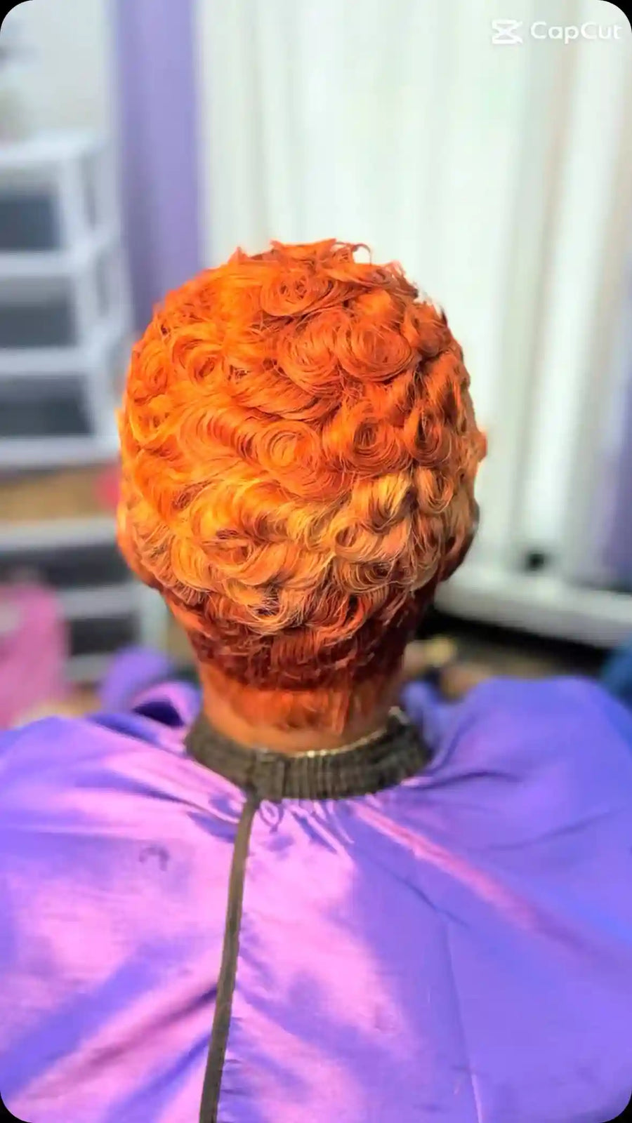 Bright copper-orange pixie cut with layered pin curls and a tapered nape, hairstylist located in Chesterfield, VA