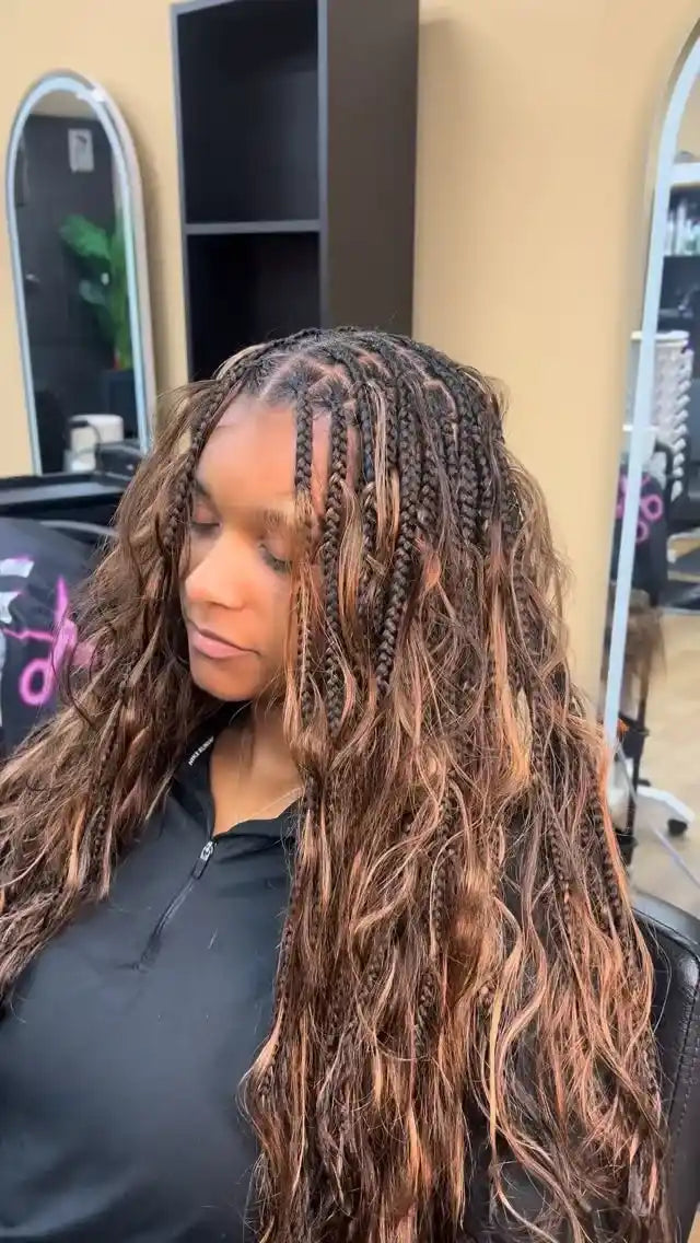 Long brown boho knotless braids with loose wavy curls, hairstylist located in Reisterstown, MD