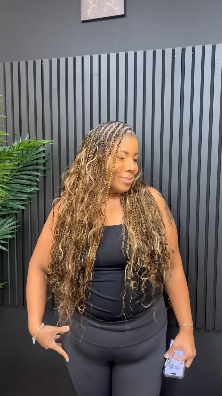 Long blonde boho knotless braids with wavy curls, hairstylist located in Reisterstown, MD